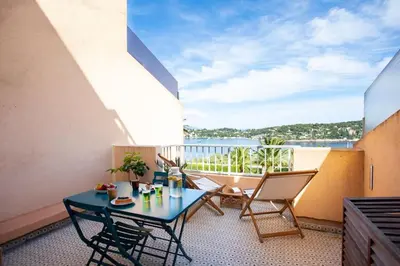 a balcony with a table and chairs and a view at L20 Stunning sea view, terrace, parking, AC, Wifi in Nice
