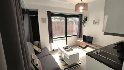 a small living room with a couch and a window at Dana centre mer 25 in Nice