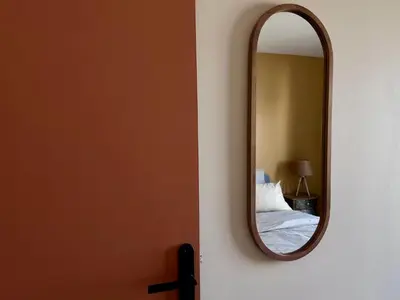 a mirror on a wall next to a bedroom at Charmant appartement à Nice in Nice