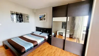 a bedroom with a bed and a large closet at Duplex Apartment, Sea View and Swimming Pool in Nice