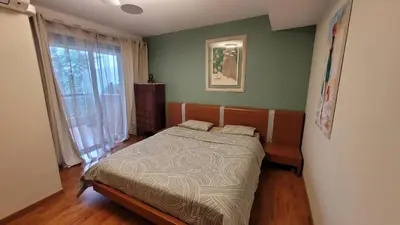 a bedroom with a bed in a room with a window at Duplex Apartment, Sea View and Swimming Pool in Nice