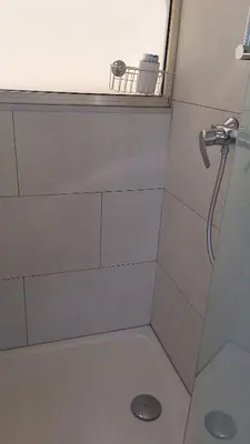a bathroom with a shower with a shower head at Chambre d'hôtes pleine vue mer in Nice