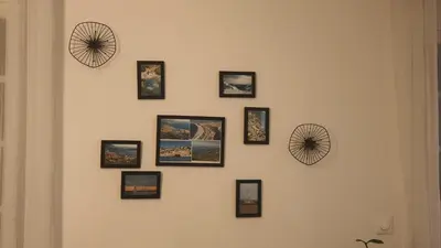 a wall with framed pictures on a wall at chez steph in La Trinité