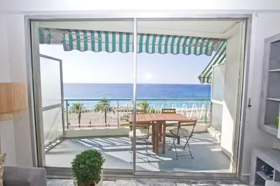 a dining room with a view of the ocean at Luxury Sea Front Condo Milord in Nice