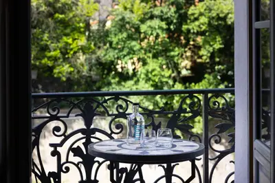 a table on a balcony with glasses on it at Palais Ségurane Boutique Hôtel in Nice