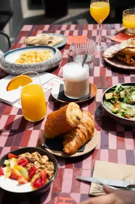 a table topped with plates of food and drinks at Palais Ségurane Boutique Hôtel in Nice