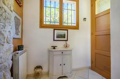 a room with a white cabinet and a window at Studio charmant à Cagnes-sur-Mer de 35 m² + piscine privée in Cagnes-sur-Mer
