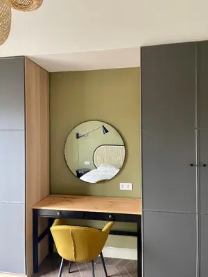 a room with a mirror and a yellow chair at Appartement moderne avec une belle vue in Nice