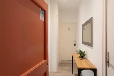a hallway with a wooden table and a mirror at L26 Old Town central 5mins walk to Sea front AC WIFI in Nice