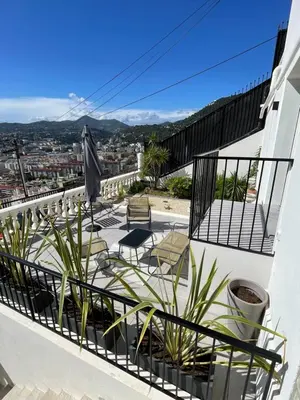 a balcony with chairs and plants on a building at Fully equiped newly refurbished studio with an incredible view in Nice in Nice