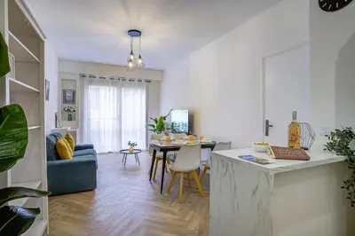 a kitchen and living room with a table and a couch at Maison Bianchi - Downtown Alsace Lorraine in Nice
