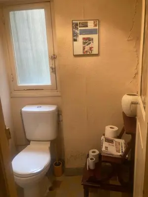 a bathroom with a white toilet and a window at Appartement dans le Vieux-Nice in Nice