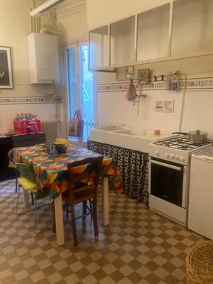 a kitchen with a table and a stove at Appartement dans le Vieux-Nice in Nice