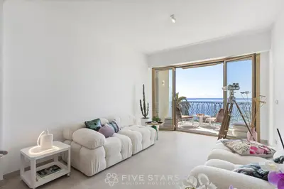 a living room with white furniture and a large window at Suite Grand Sud FSHH in Nice