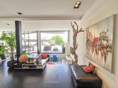 a living room with a couch and a table at Villa Les Oliviers by Interhome in Nice