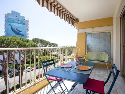 a balcony with a blue table and chairs on a balcony at Studio le ponant by Interhome in Saint-Laurent-du-Var