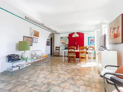 a living room with a table and a dining room at Apartment Le Palais Foch by Interhome in Villefranche-sur-Mer