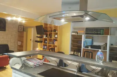 a kitchen with a table and chairs in a room at F4 6 Couchages Terrasse Proche Centre in Nice
