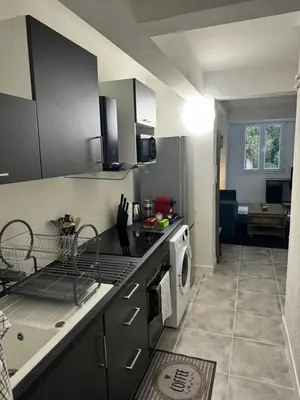 a kitchen with a stove top oven next to a microwave at Studio à Nice - 10 min de la plage in Nice