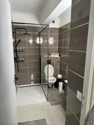 a bathroom with a toilet and a glass shower at Studio à Nice - 10 min de la plage in Nice