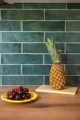 a pineapple on a cutting board next to a plate of cherries at Pink Palace - Quartier Authentique Libération in Nice