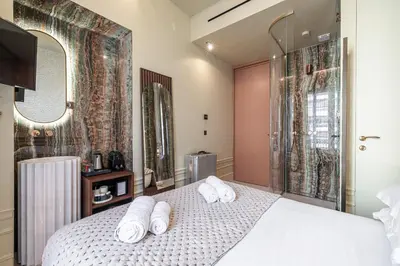 a bedroom with a bed with towels on it at Naomi Nice in Nice