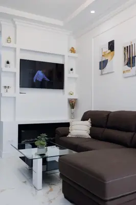 a living room with a couch and a tv at Appartement 3 PIECES NICE Promenade in Nice