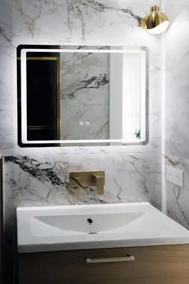 a bathroom with a white sink and a mirror at Appartement 3 PIECES NICE Promenade in Nice