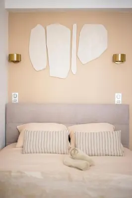 a bed with a towel laying on top of it at Luxueux, spacieux et tout équipé à 5 min du port in Nice