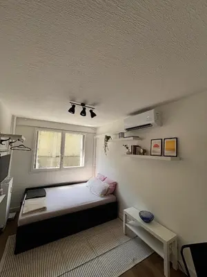 a small bedroom with a bed and a window at Nice appartement for 2 adults with air-conditioning in Nice