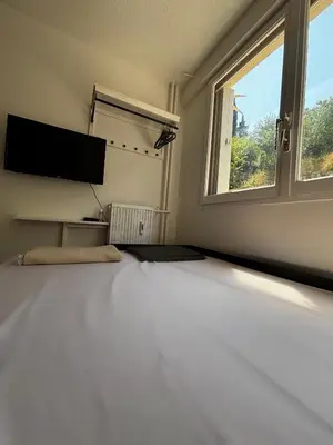 a bedroom with a large bed and a window at Nice appartement for 2 adults with air-conditioning in Nice