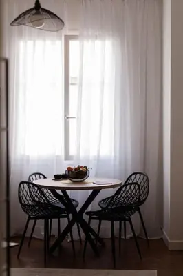 a table with chairs and a bowl of fruit on it at New Central Stylish 2 min from the beach Apartment in Nice