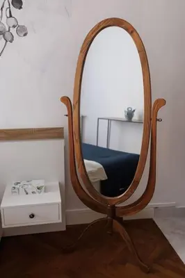 a wooden mirror with a chair in a room at New Central Stylish 2 min from the beach Apartment in Nice
