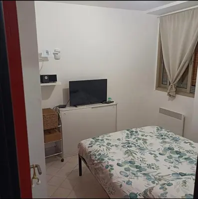 a bedroom with a bed and a flat screen tv at Apartment Massena - super central in Nice