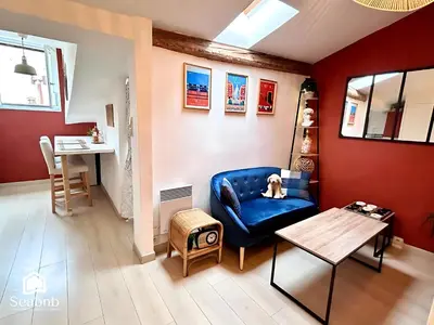 a living room with a blue couch and a table at Little Nest - Old Town - Breakfast - Wifi - AC in Nice