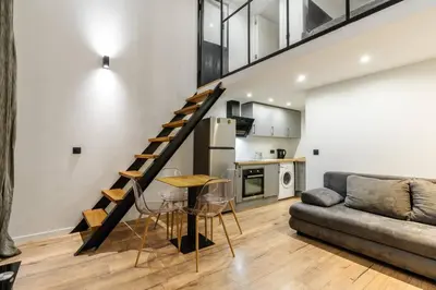 a living room with a staircase and a couch at Cocon au cœur du Vieux Nice in Nice