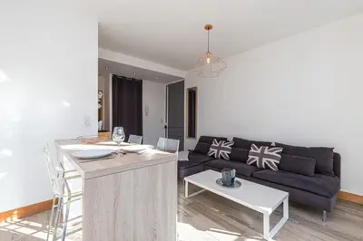 a living room with a couch and a table at 253 MONT BORON - Appartement 2p - Balcon plein sud - Climatisation in Nice