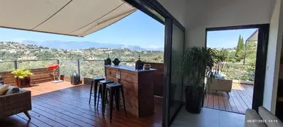a balcony with a bar with a view of the mountains at VILLA MODERNE PISCINE JACUZZi in Nice