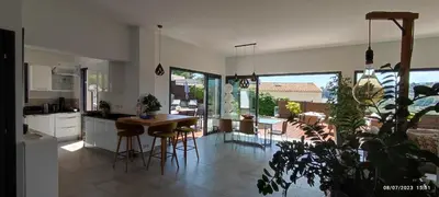 a kitchen and dining room with a table and chairs at VILLA MODERNE PISCINE JACUZZi in Nice
