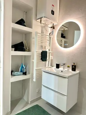 a bathroom with a white sink and a mirror at Studio Cosy à Nice Centre in Nice