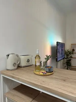 a counter with a table with a toaster and food on it at Studio Cosy à Nice Centre in Nice