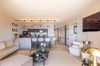 a living room with a couch and a table at Les Belles Terres - Résidence avec piscine vue mer in Nice