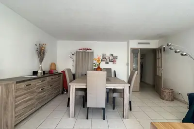 a kitchen and dining room with a table and chairs at Nice Proche Mer in Nice