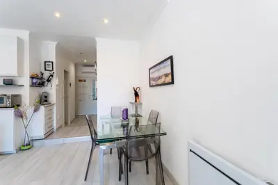 a dining room with a glass table and chairs at PORT CARNOT AP4405 By Riviera Holiday Homes in Nice
