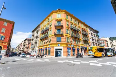 a yellow building on a city street with a bus at PORT CARNOT AP4405 By Riviera Holiday Homes in Nice