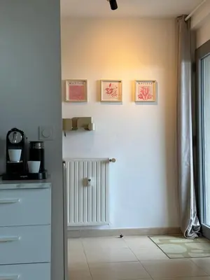 a kitchen with a radiator and three pictures on the wall at Art Studio Nice in Nice