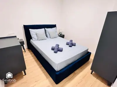 a bedroom with a bed with two speakers at Charming Downtown - AC - WiFi - Private Entrance in Nice