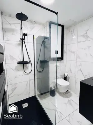 a bathroom with a glass shower with a toilet at Charming Downtown - AC - WiFi - Private Entrance in Nice