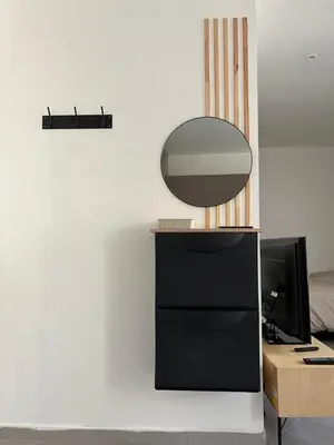 a desk with a computer and a mirror on a wall at République in Nice