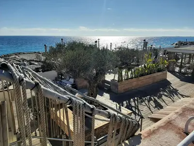 a view of the ocean from the stairs of a resort at Studio piscine climatisation tennis in Nice